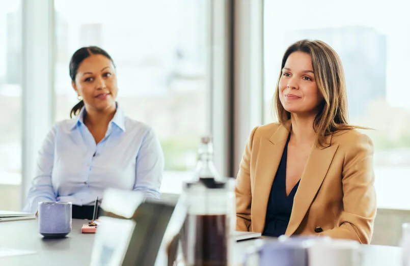 Two business owners listening during a planning meeting